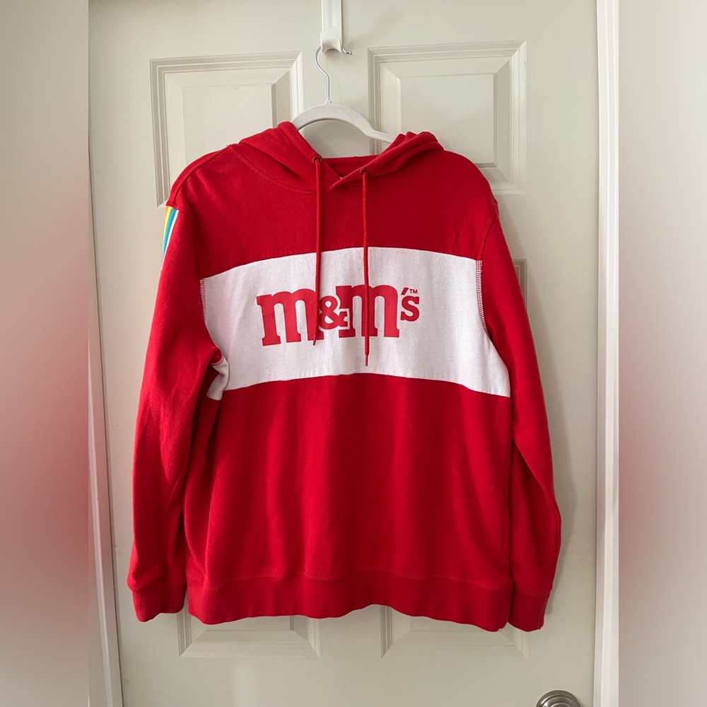 Men’s Red M&M’s logo hooded sweatshirt with rainbow stripes along arms size M